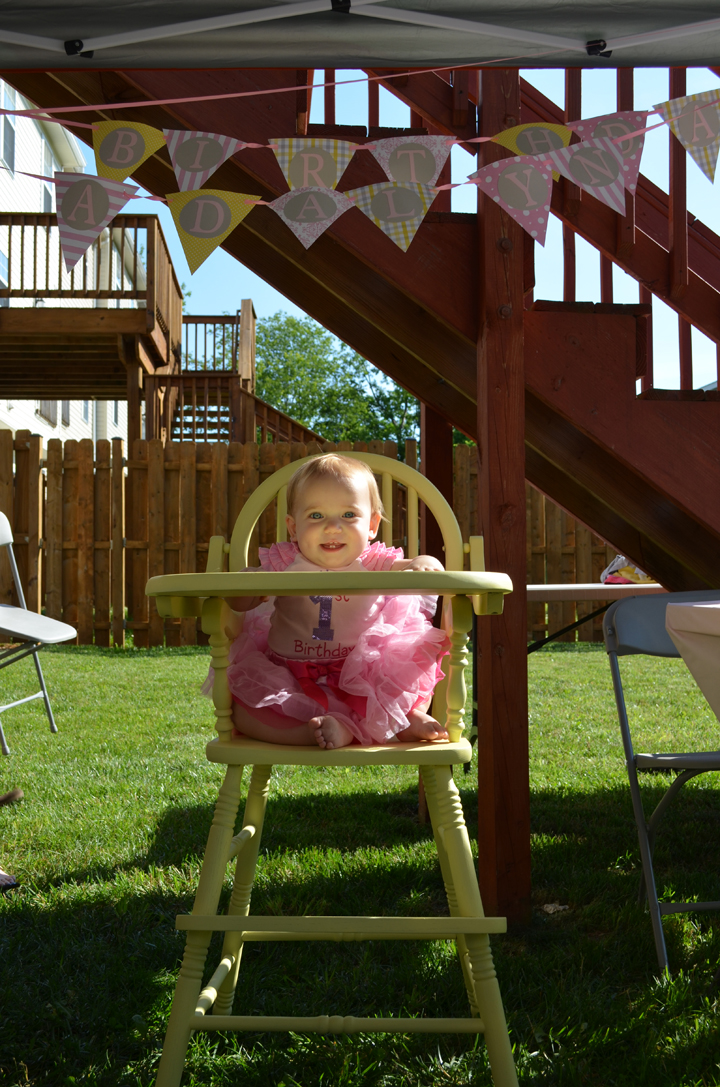 She looks so cute in her yellow wooden highchair.